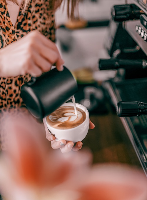 A baristas serves espresso