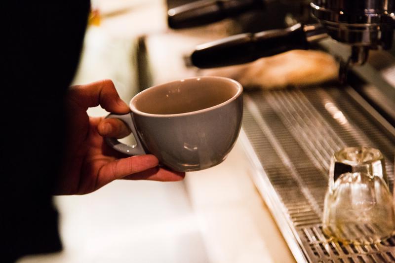 barista holding a cup of espresso