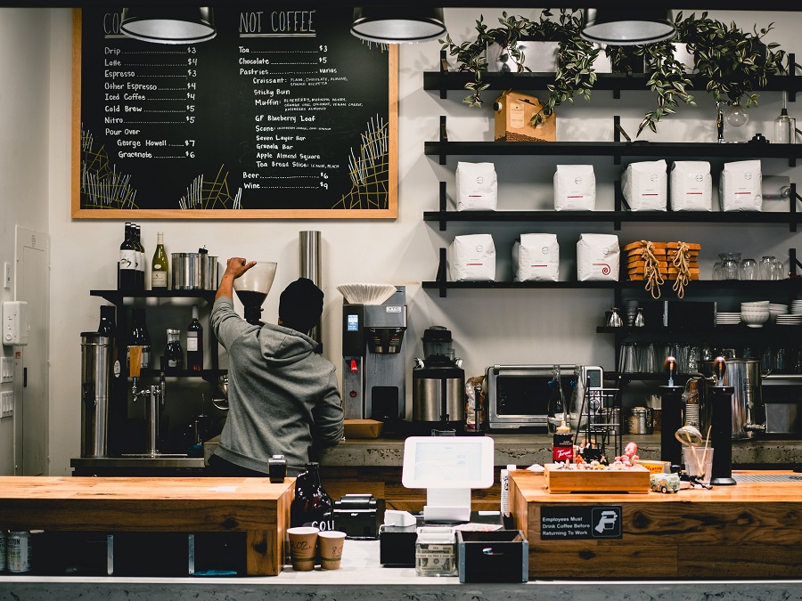 a barista works at a coffee shop