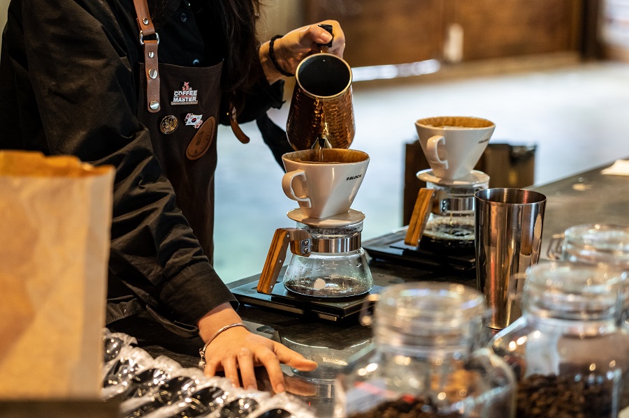 A barista pours coffee