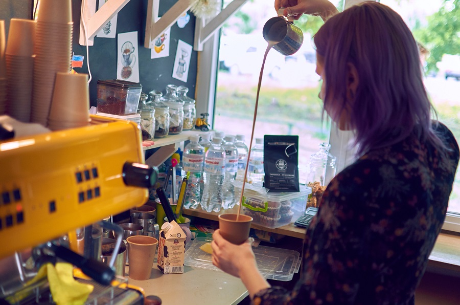 A barista serves espresso