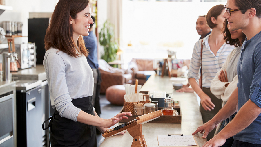 A barista serves customers