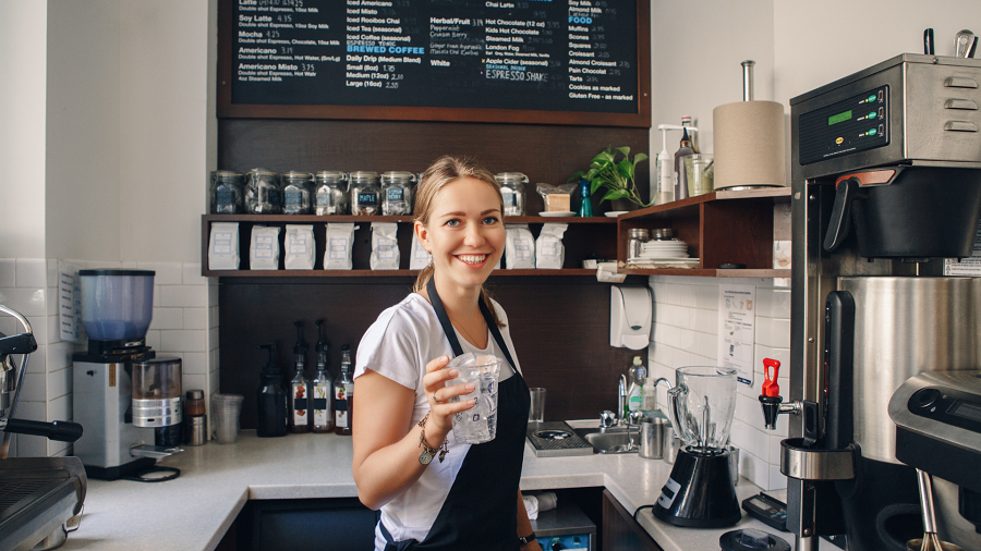 A barista serves coffee