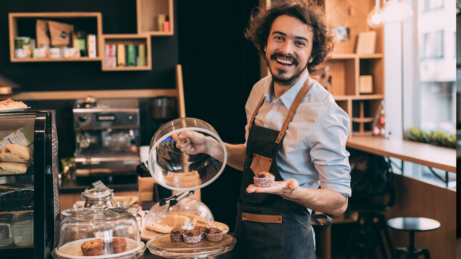 A barista serves pastries