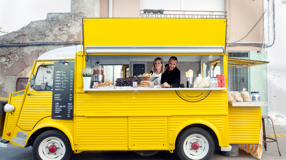 How to Start a Mobile Coffee Truck Business. Coffee Truck owners smile at the camera.